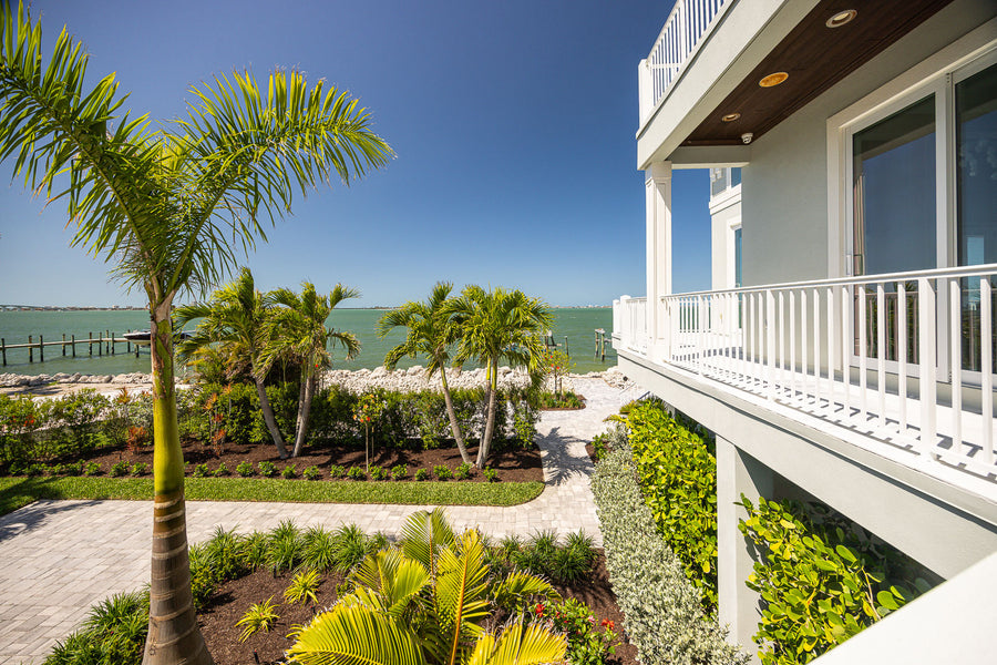 Paver walkway through tropical planting beside a Satellite Beach home
